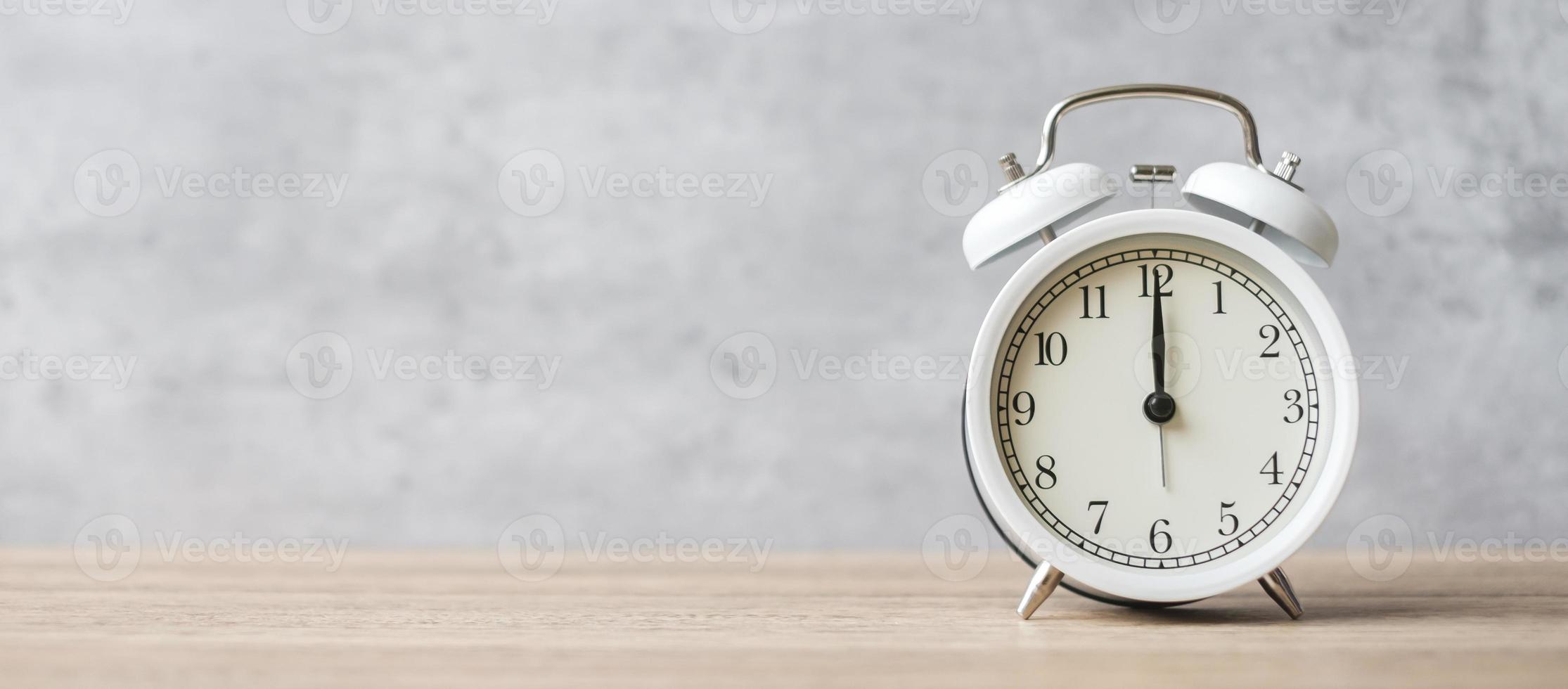 Vintage alarm clock on wooden table background and copy space for text. Activity, daily routine, morning, countdown, workout and Work life balance concept photo