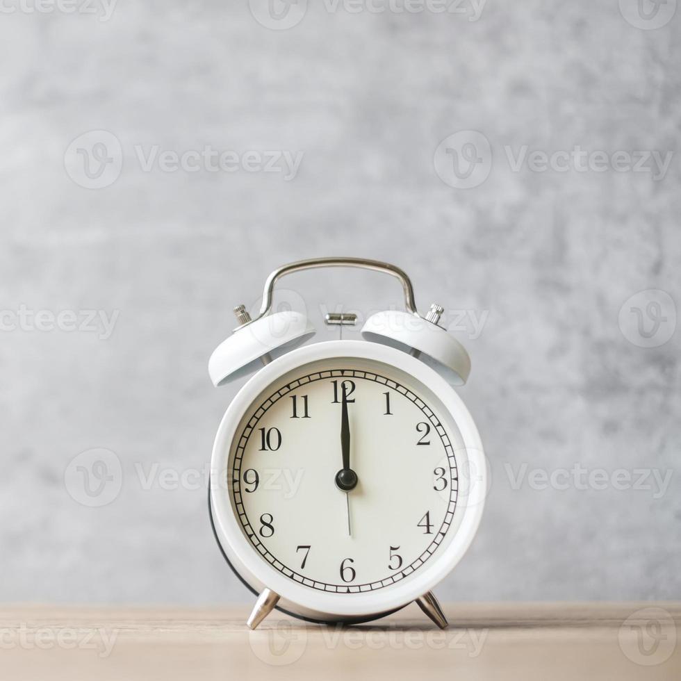 Vintage alarm clock on wooden table background and copy space for text. Activity, daily routine, morning, countdown, workout and Work life balance concept photo