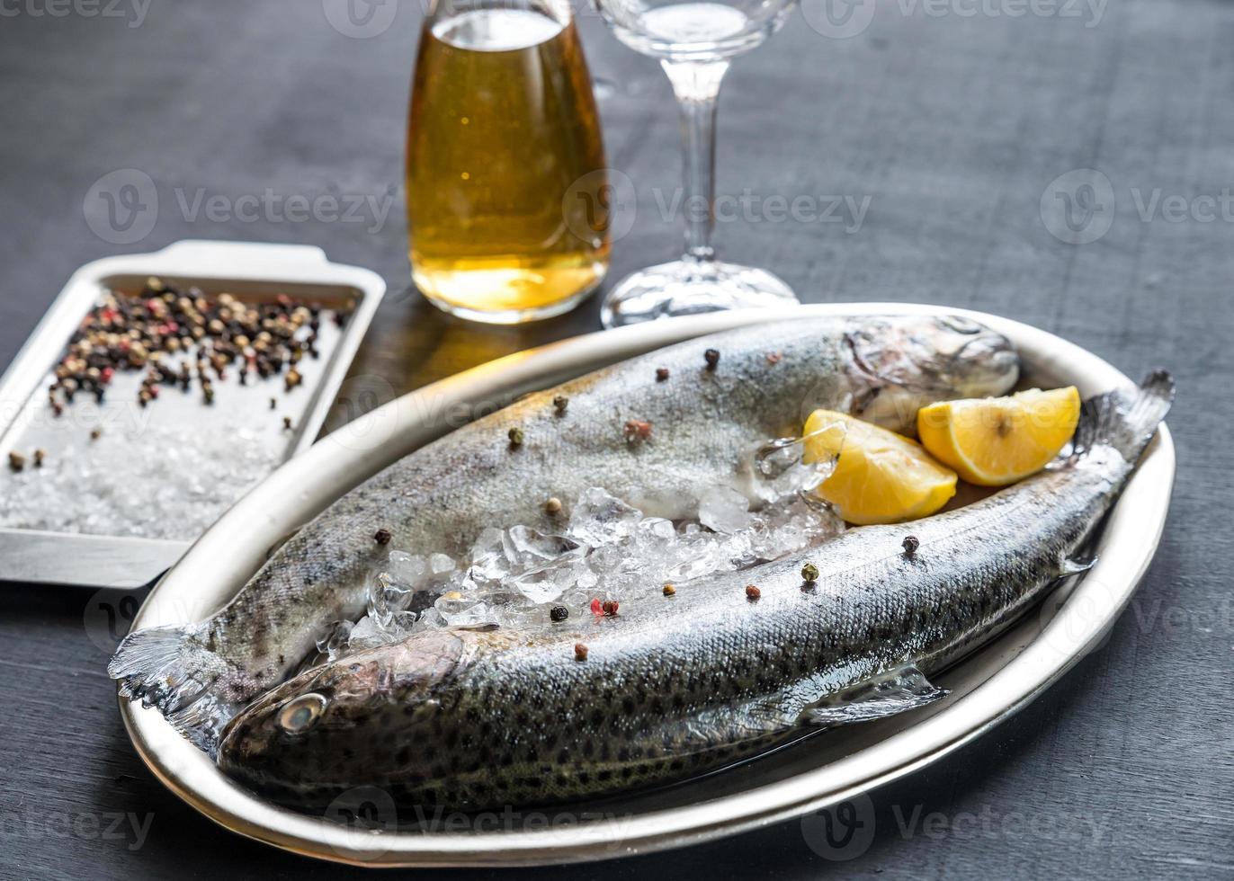 Fresh trouts in ice on the vintage metal tray photo