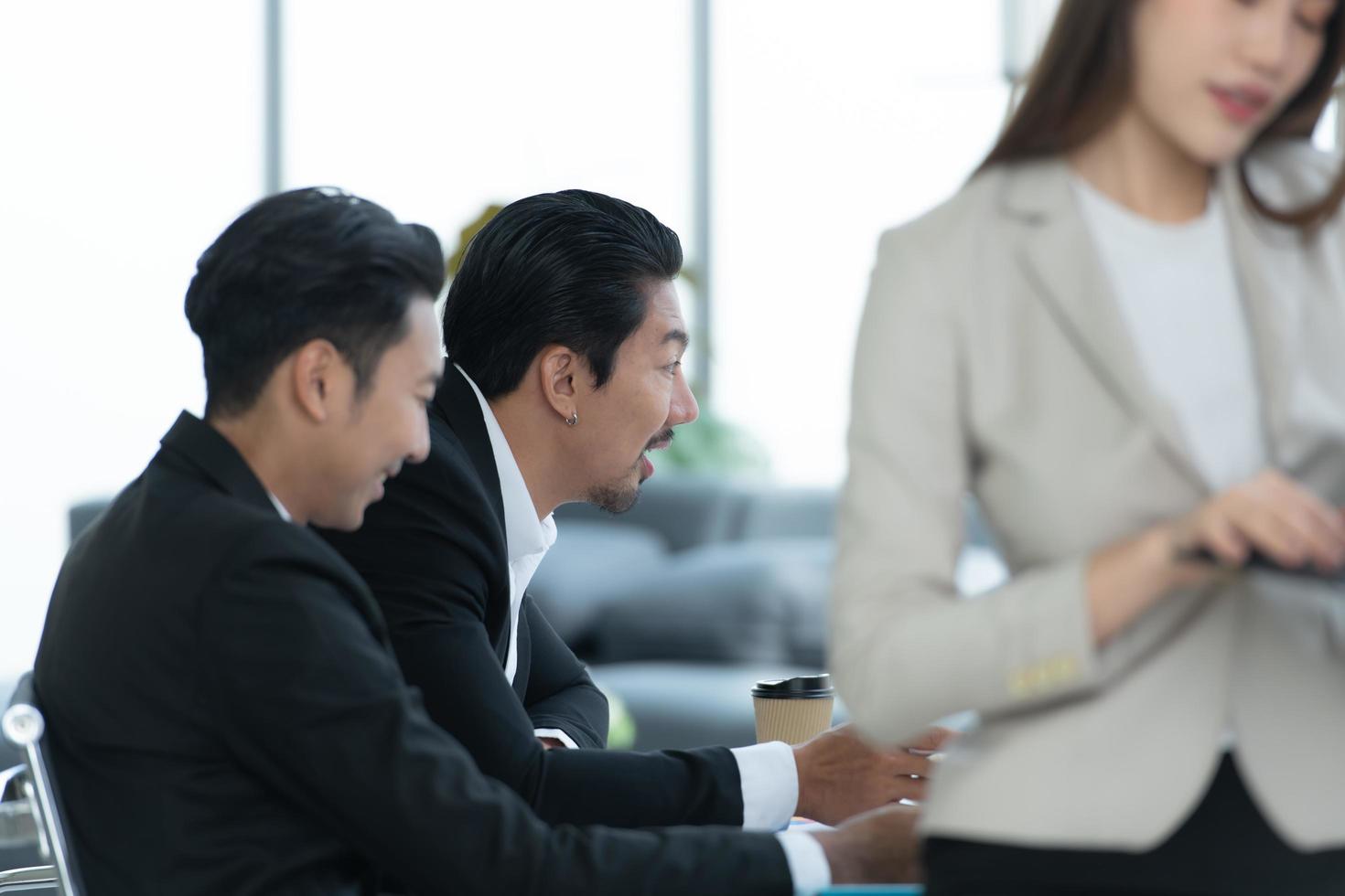 Young entrepreneurs in Asia Meeting to review stock investment information in the meeting room with a coordinator photo