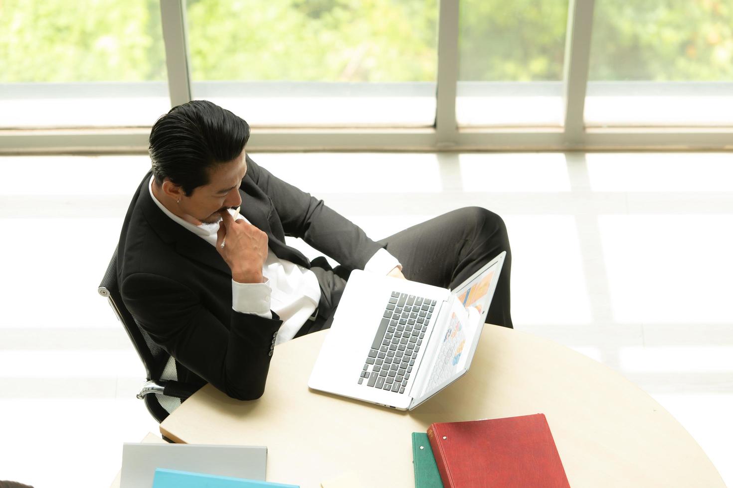 Boss is having a meeting to review investment information with the team in a meeting room with natural light photo