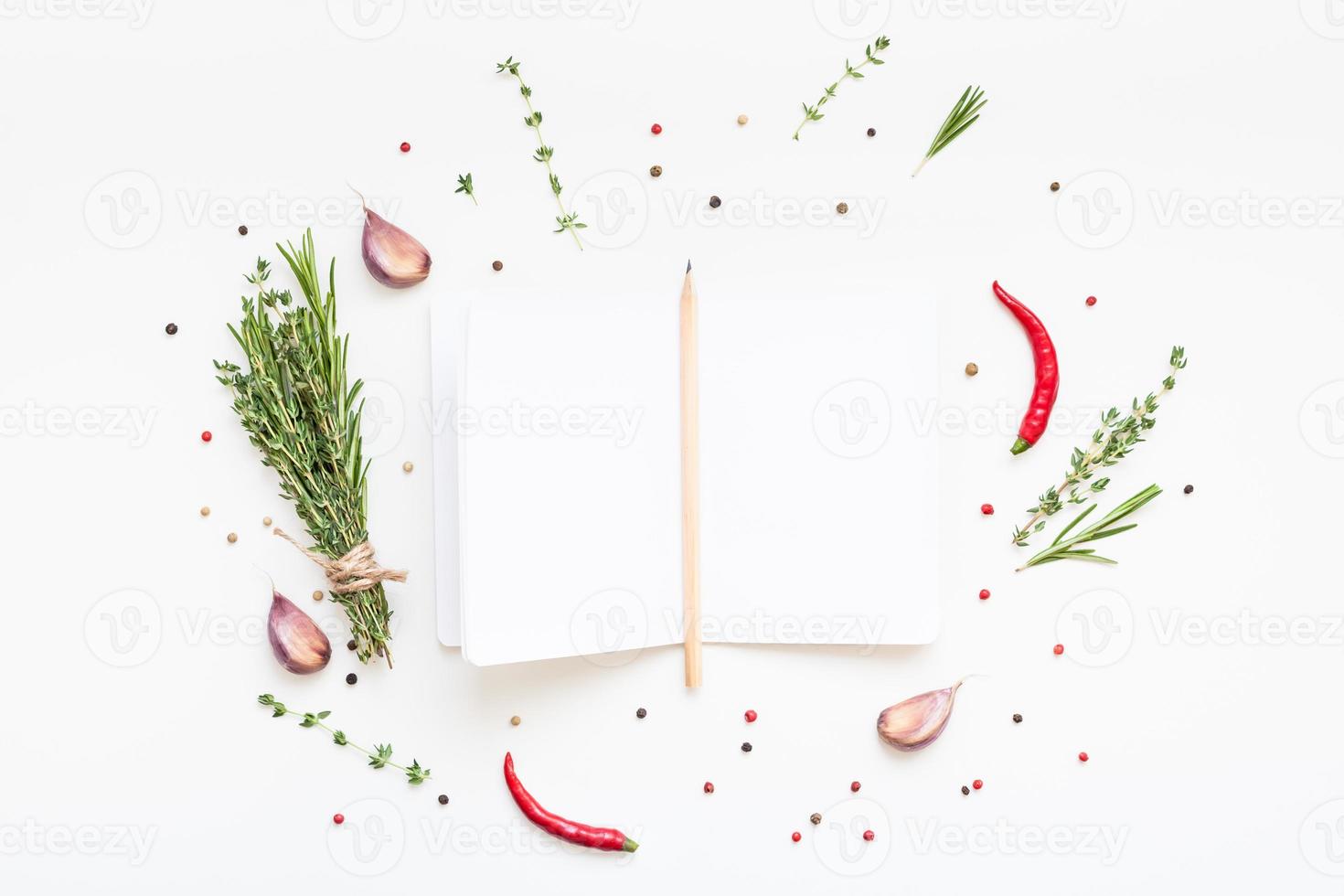 Blank notepad pages with greens herbs and spices photo