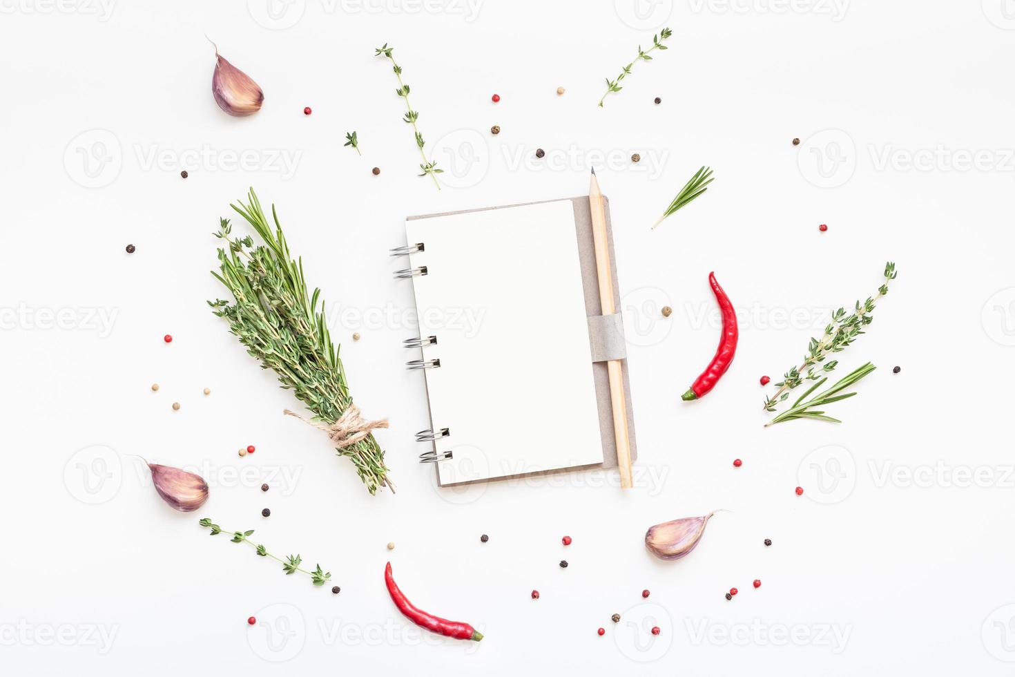 Blank notepad pages with greens herbs and spices photo