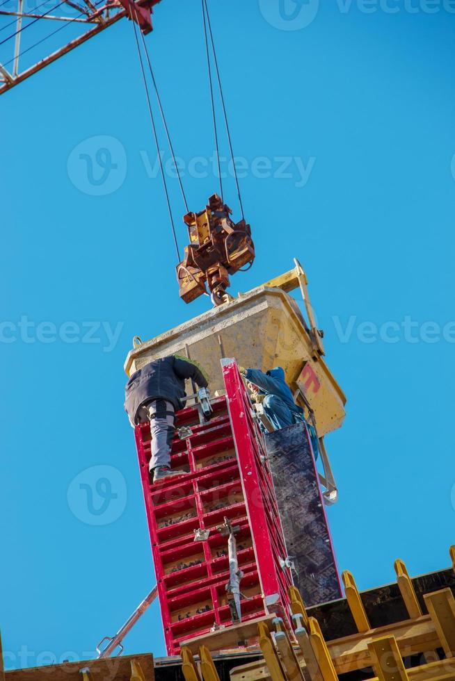 Construction formwork, reinforcement for the construction of buildings. Workers make a concrete structure photo