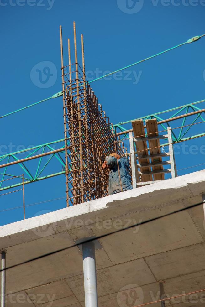 Construction formwork, reinforcement for the construction of buildings. Workers make a concrete structure photo