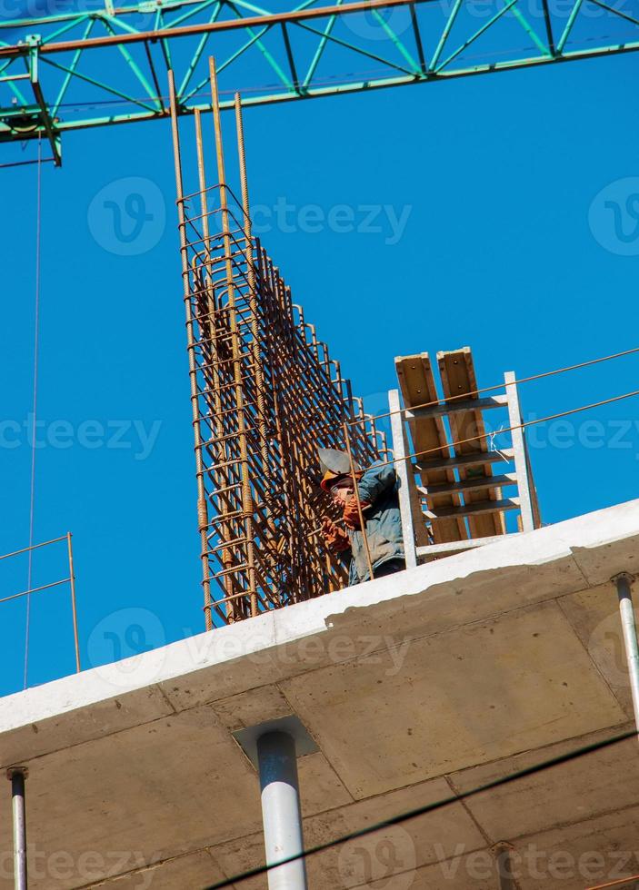Construction formwork, reinforcement for the construction of buildings. Workers make a concrete structure. photo