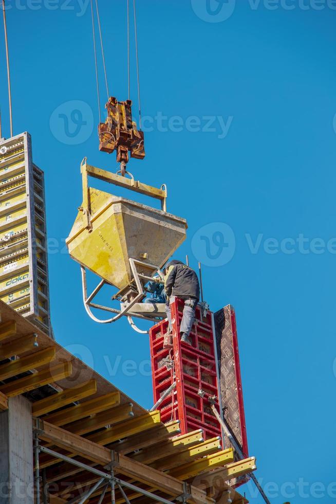 Construction formwork, reinforcement for the construction of buildings. Workers make a concrete structure. photo