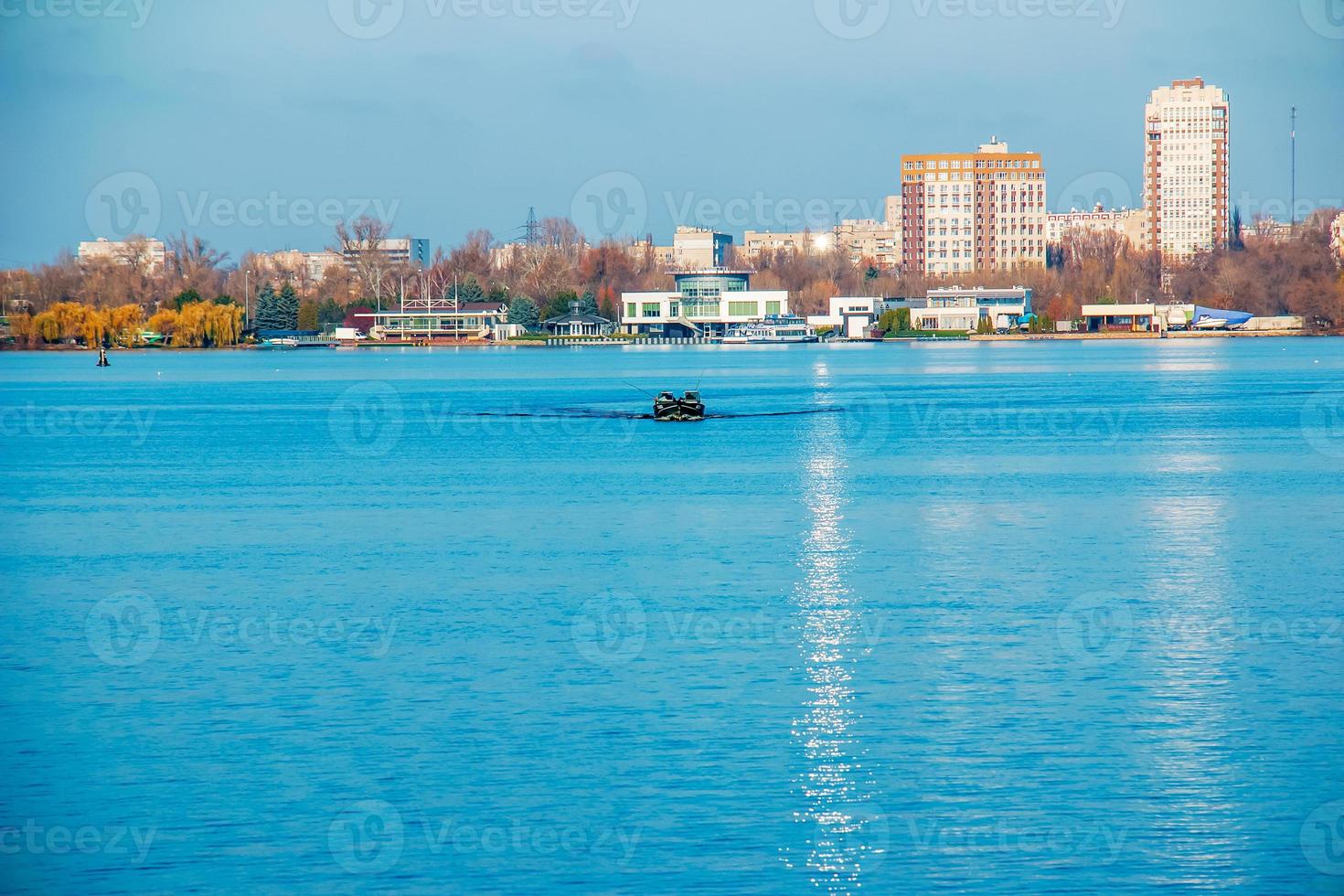 Fishermen on a boat on the river catch fish in autumn. Fishing is a special kind of sport. photo