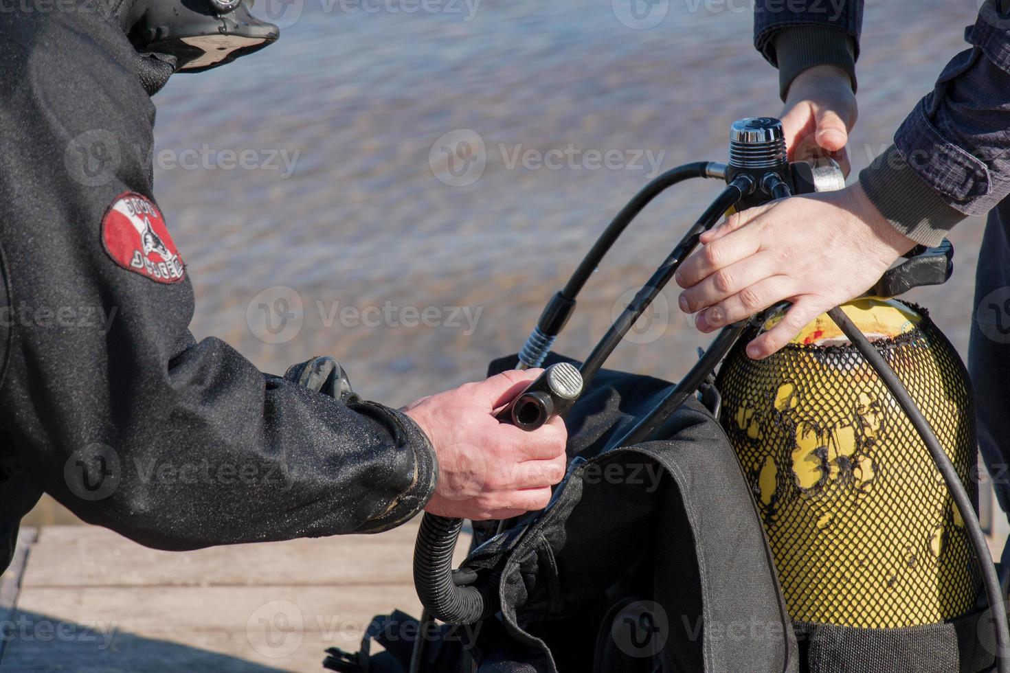 Professional diver near the river coastline. Commercial diving. Winter. photo