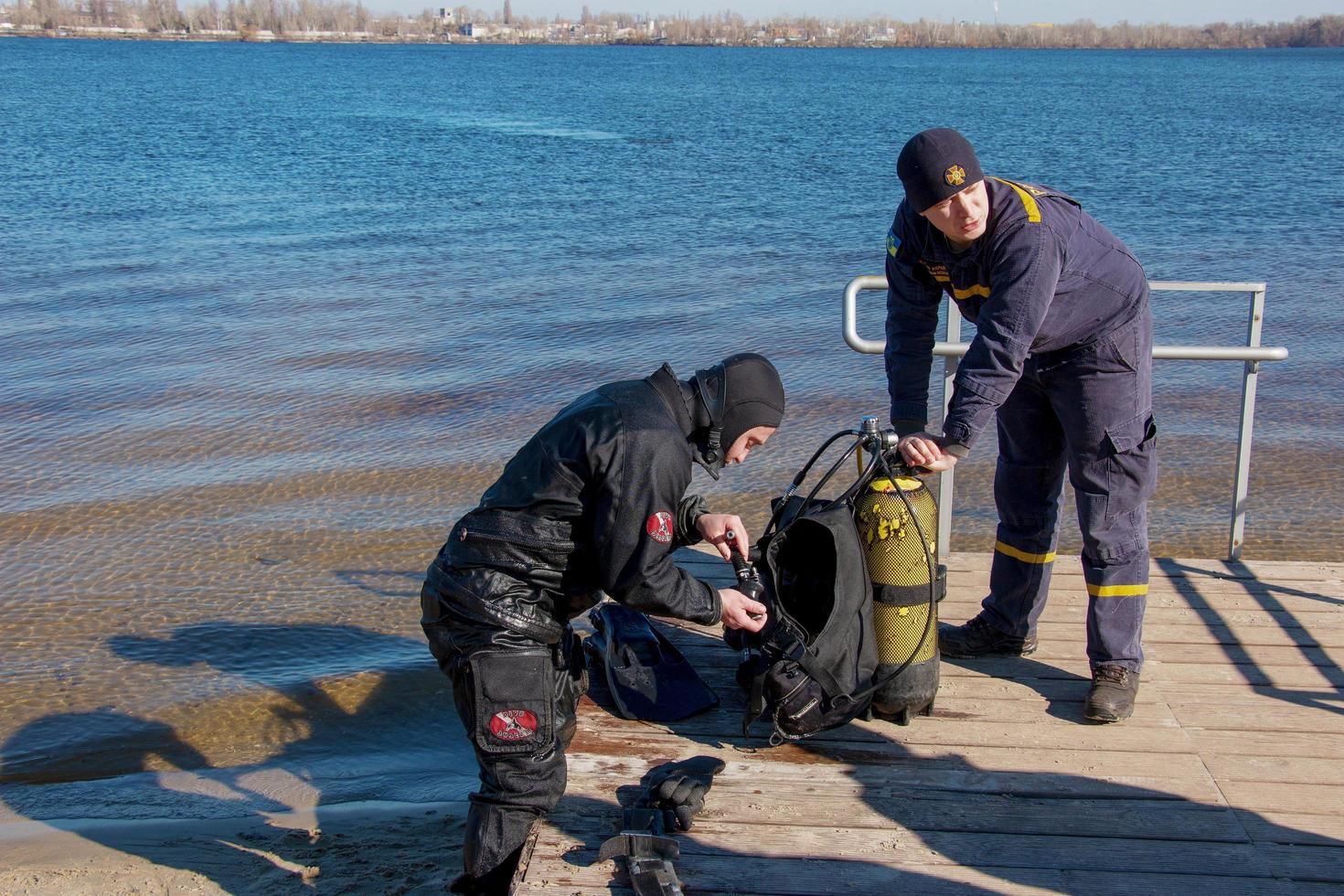 Dnepropetrovsk, Ukraine, Dnieper river - 02.21.2022 Professional diver near the river coastline. Commercial diving. Winter. photo