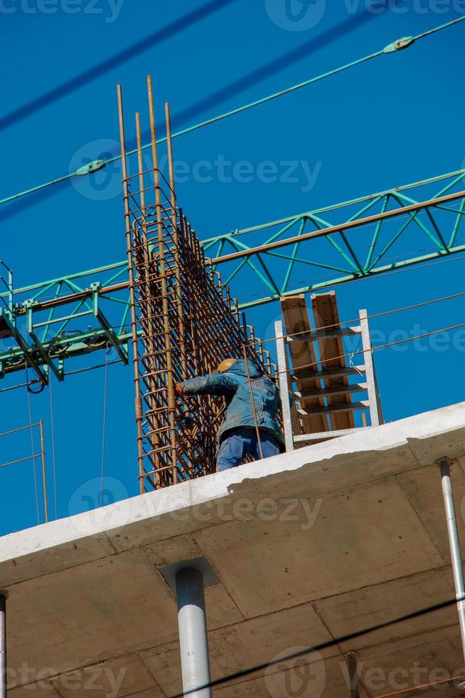 Construction formwork, reinforcement for the construction of buildings. Workers make a concrete structure photo