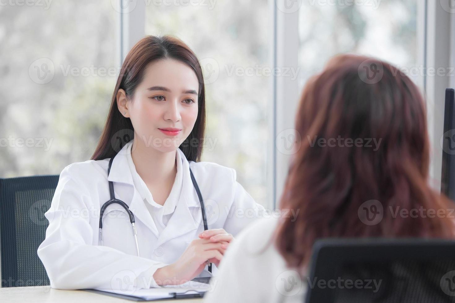 Asian elderly woman patient is checked health by professional doctor explaining while both wear medical in the examination room at hospital in health care and protection concept. photo