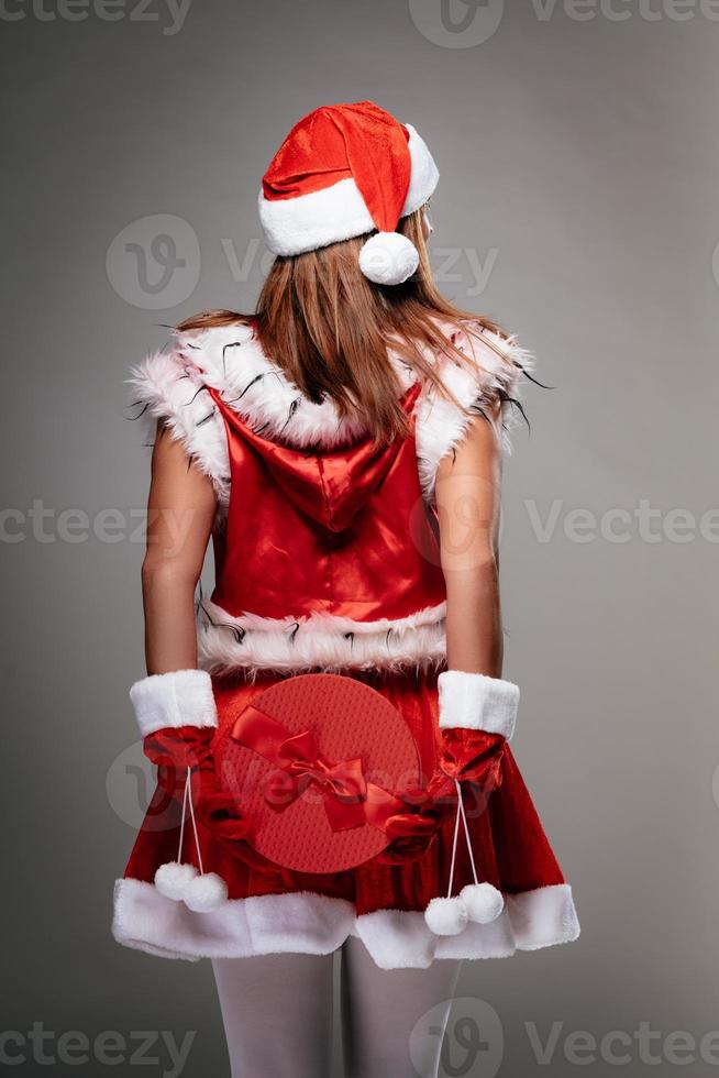 Female Santa Claus With Christmas Present photo