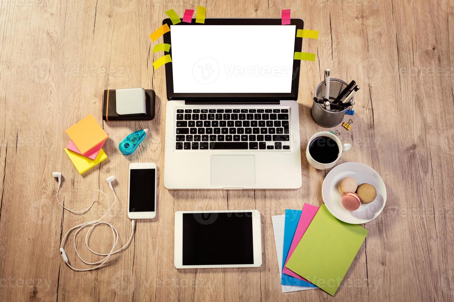 Workspace With Coffee Cup And French Macaroons photo