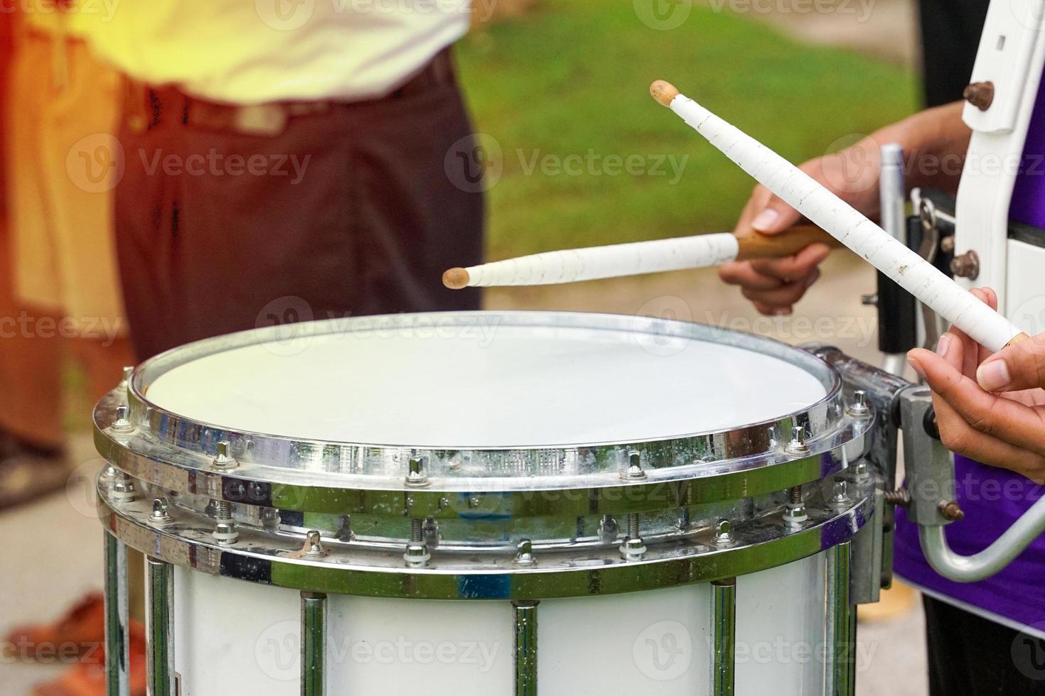 Some blurry images of Asian students playing drums during a parade practice. Soft and selective focus. photo