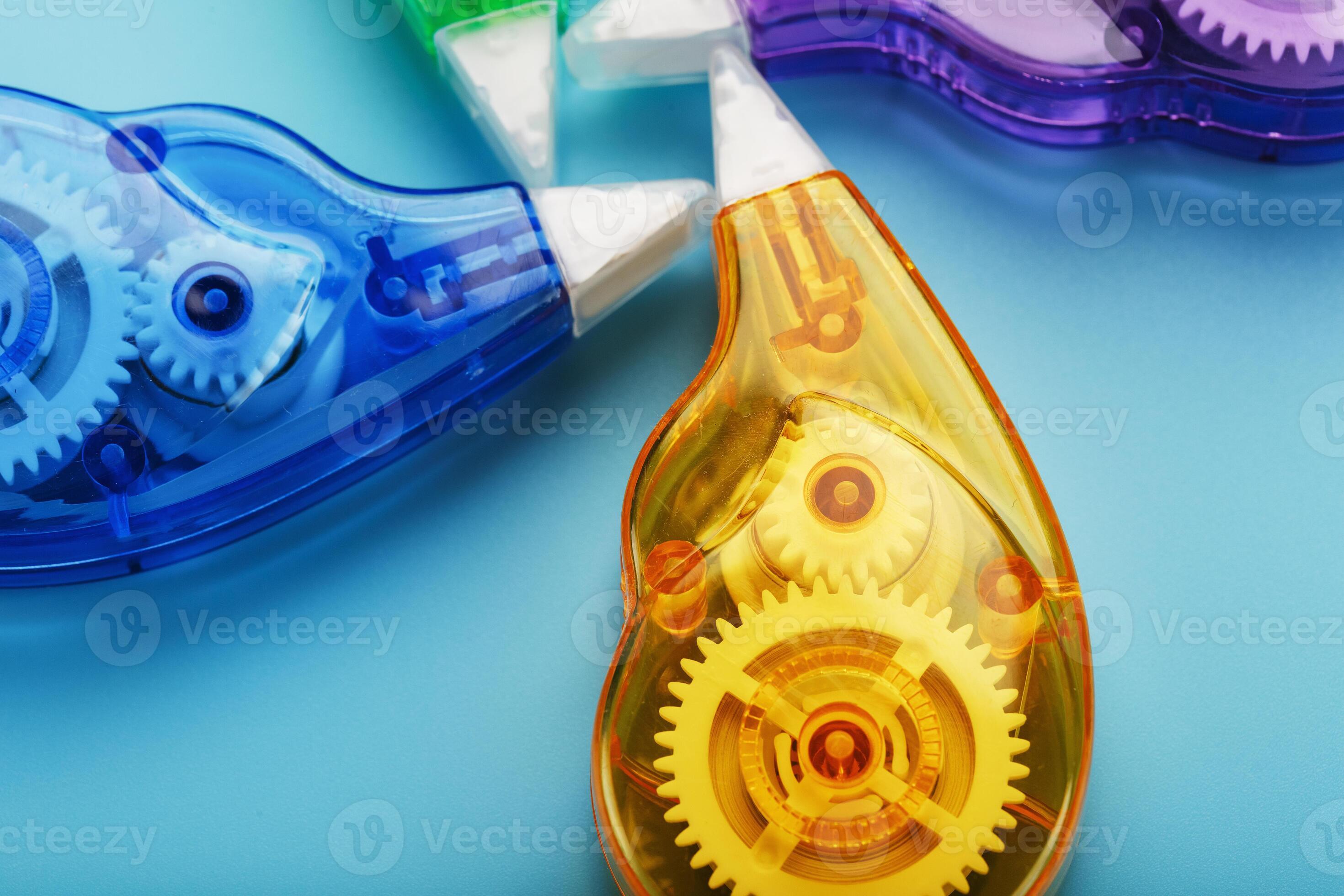 Multicolored Stationery correction tapes on a blue background
