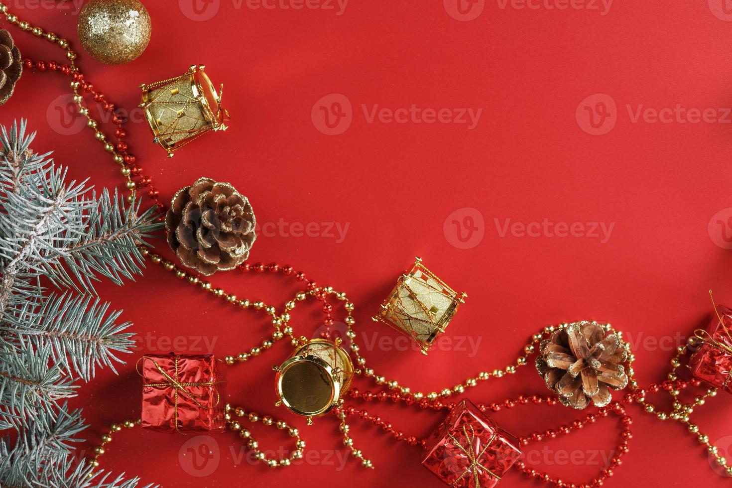 Christmas decorations with spruce branches on a red background with free space. photo