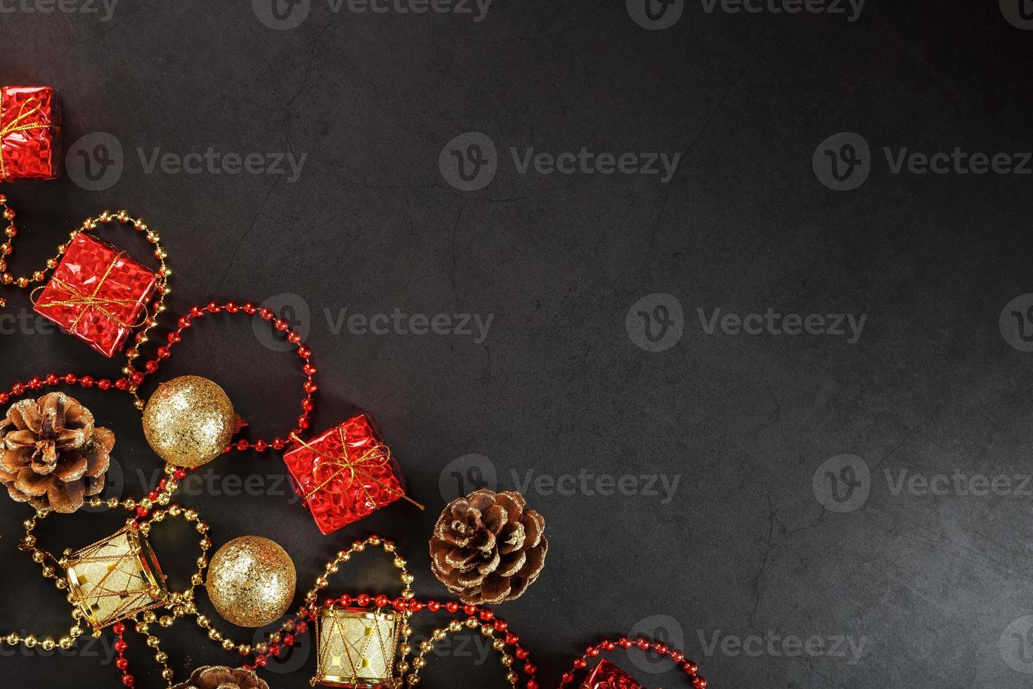 Christmas or New Years dark background with red and gold decorations for the Christmas tree with free space photo