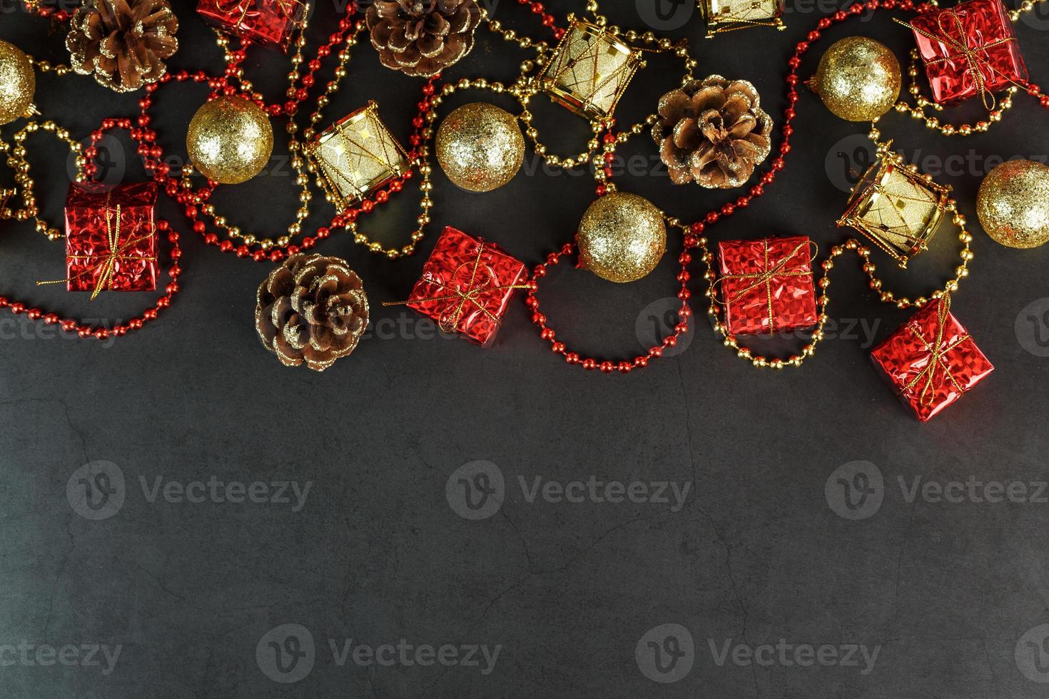 Christmas or New Years dark background with red and gold decorations for the Christmas tree with free space photo