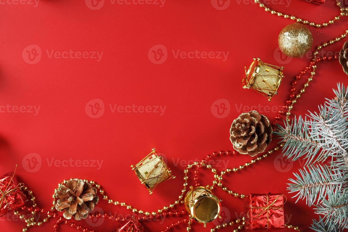 Christmas arrangement of Christmas ornaments and Christmas tree decorations on a red background. photo