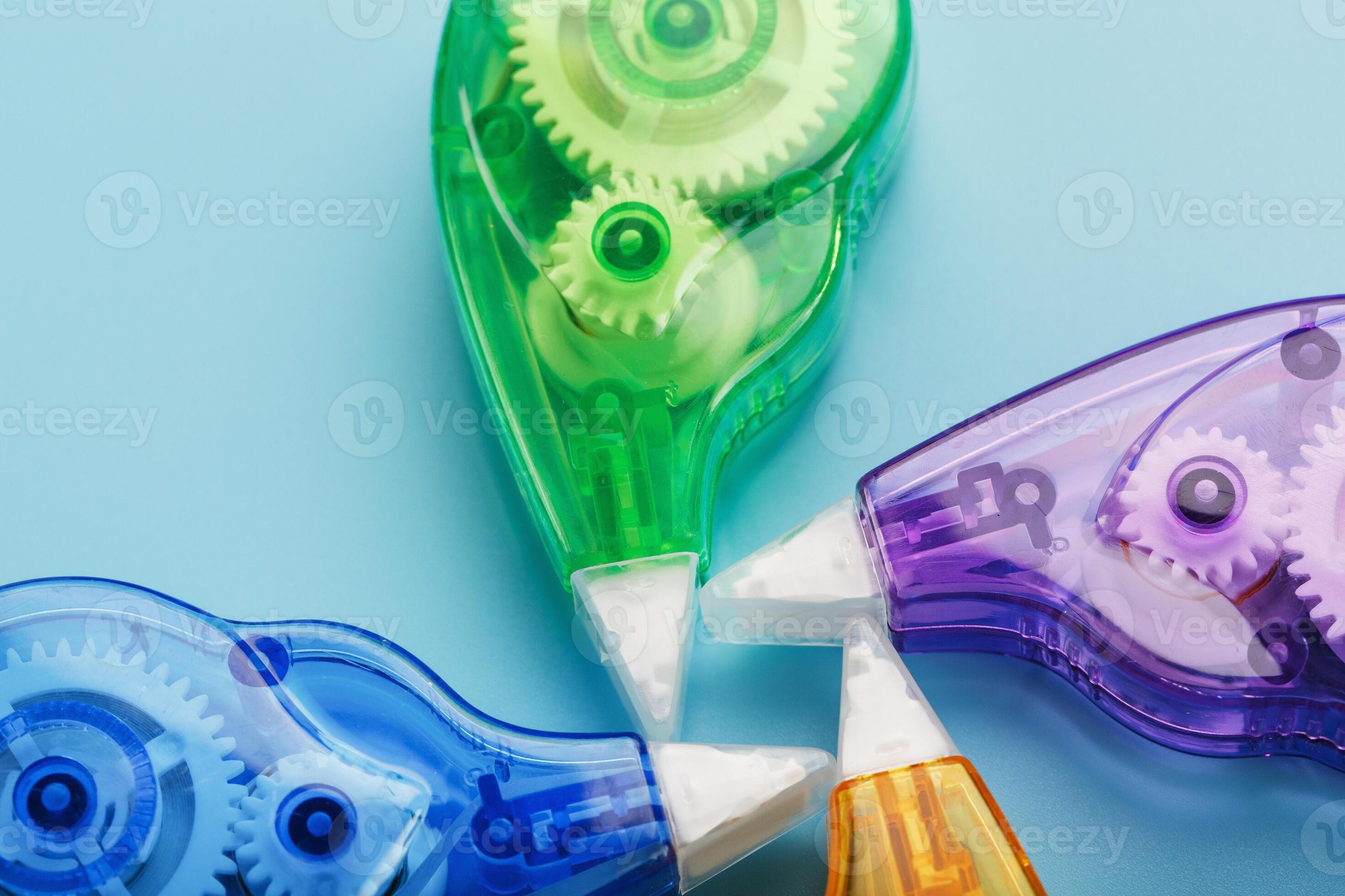 Multicolored Stationery correction tapes on a blue background