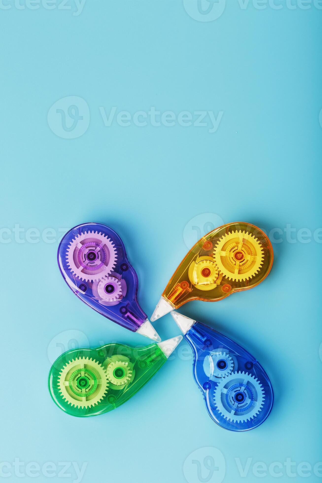 Multicolored Stationery correction tapes on a blue background