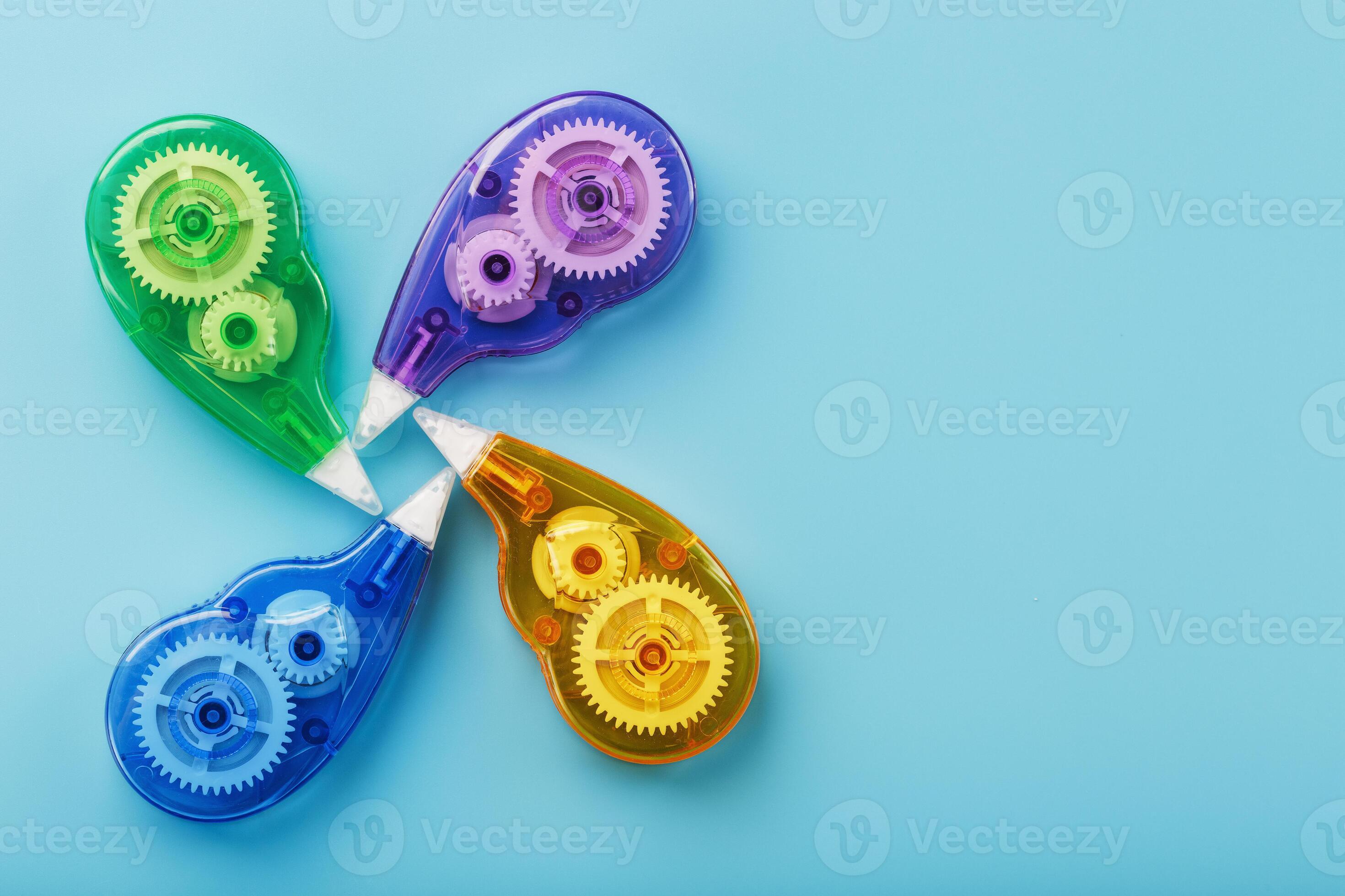 Multicolored Stationery correction tapes on a blue background