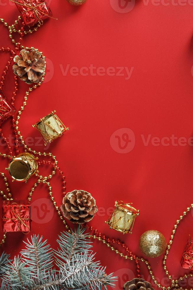 Christmas decorations with spruce branches on a red background with free space. photo