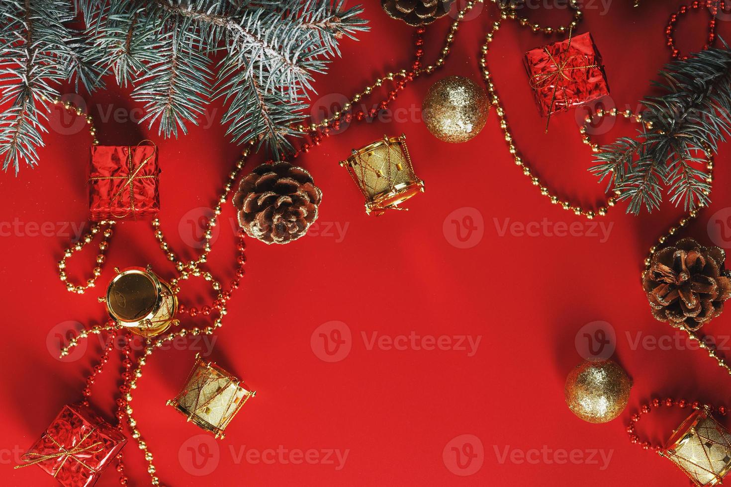 Christmas decorations with spruce branches on a red background with free space. photo