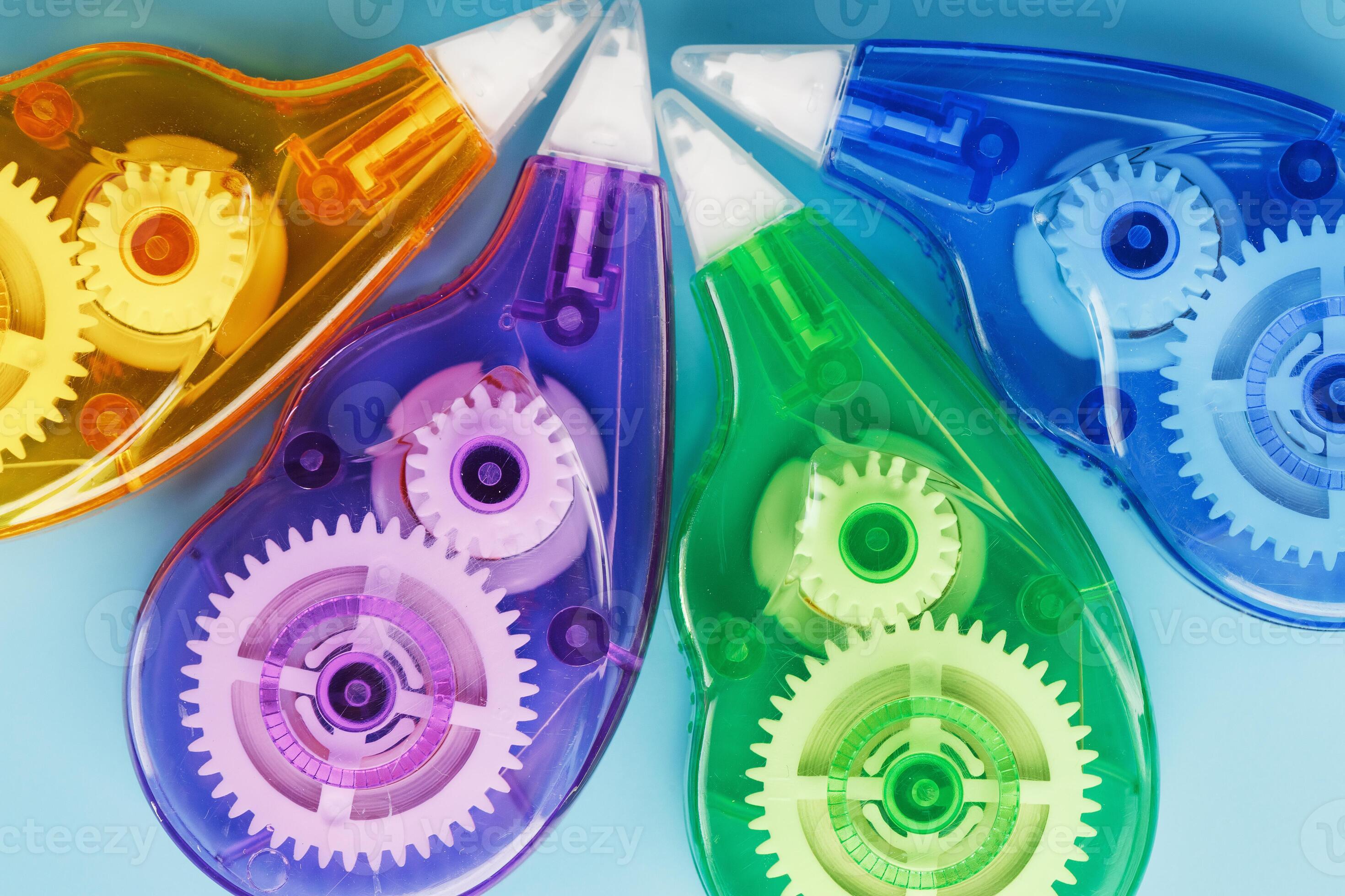 Multicolored Stationery correction tapes on a blue background