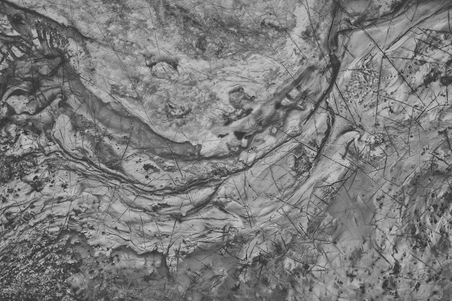 Spread on the ground cracked liquid metal surface flat background. photo