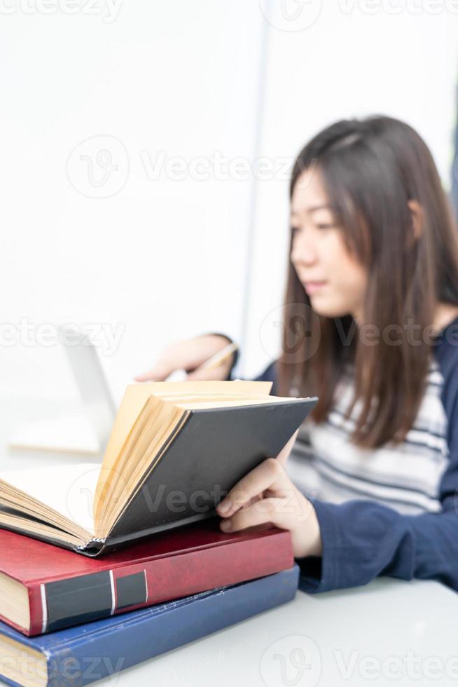 Young female sitting in living room and learning online photo