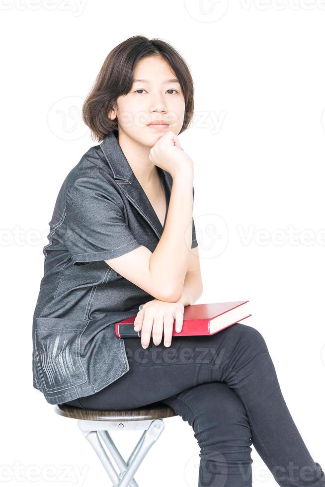 Woman reading a book sitting on chair photo