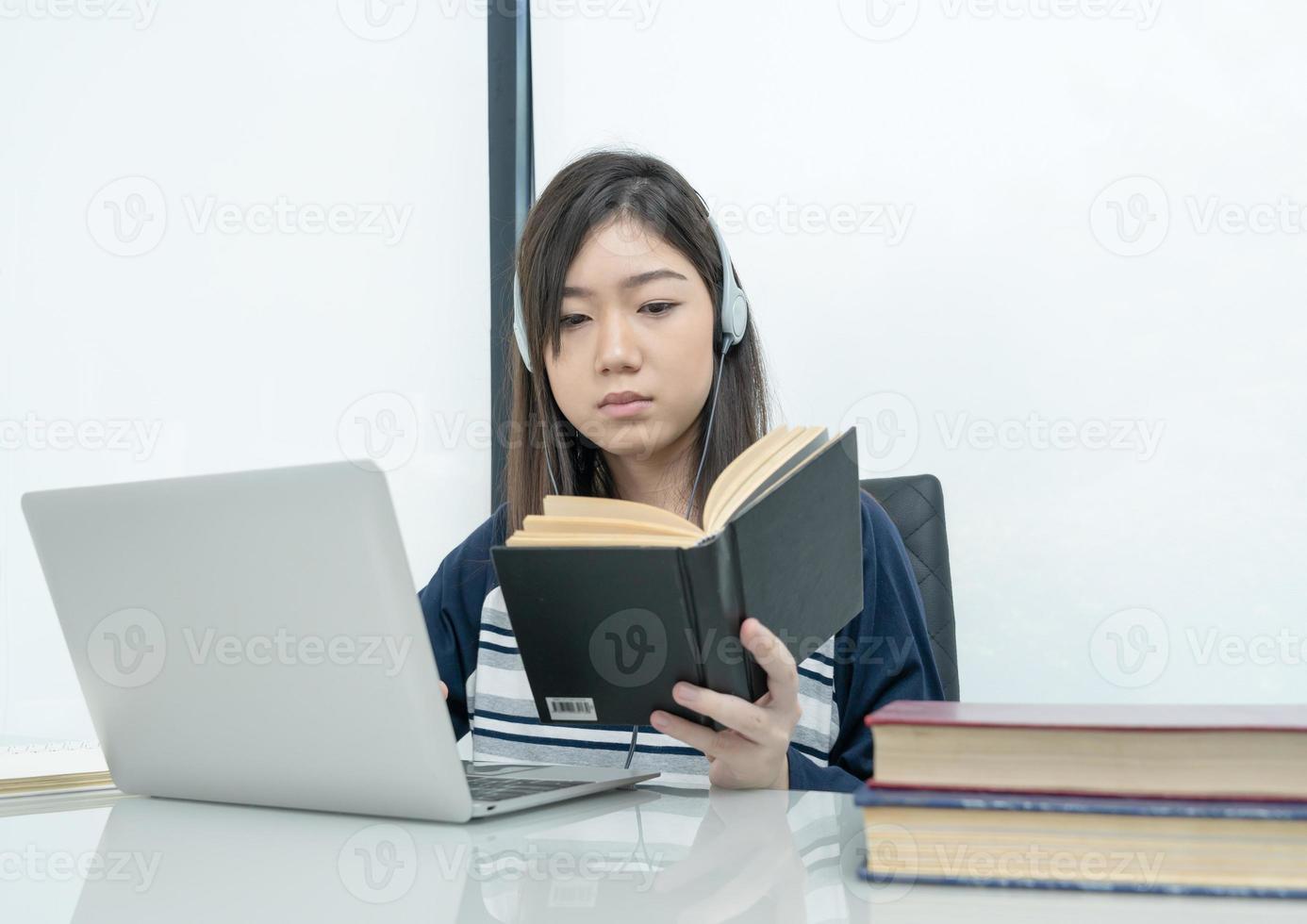 Student sitting in living room and learning online photo