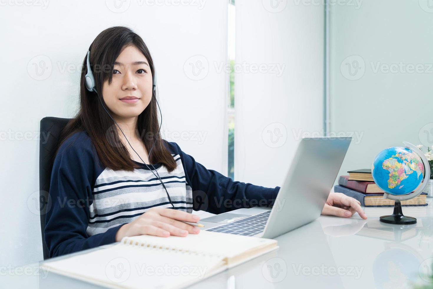 estudiante sentado en la sala de estar y aprendiendo en línea foto