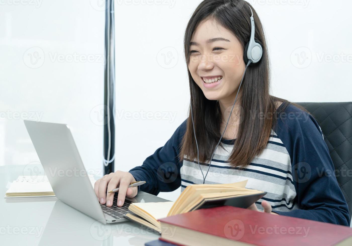 Student sitting in living room and learning online photo