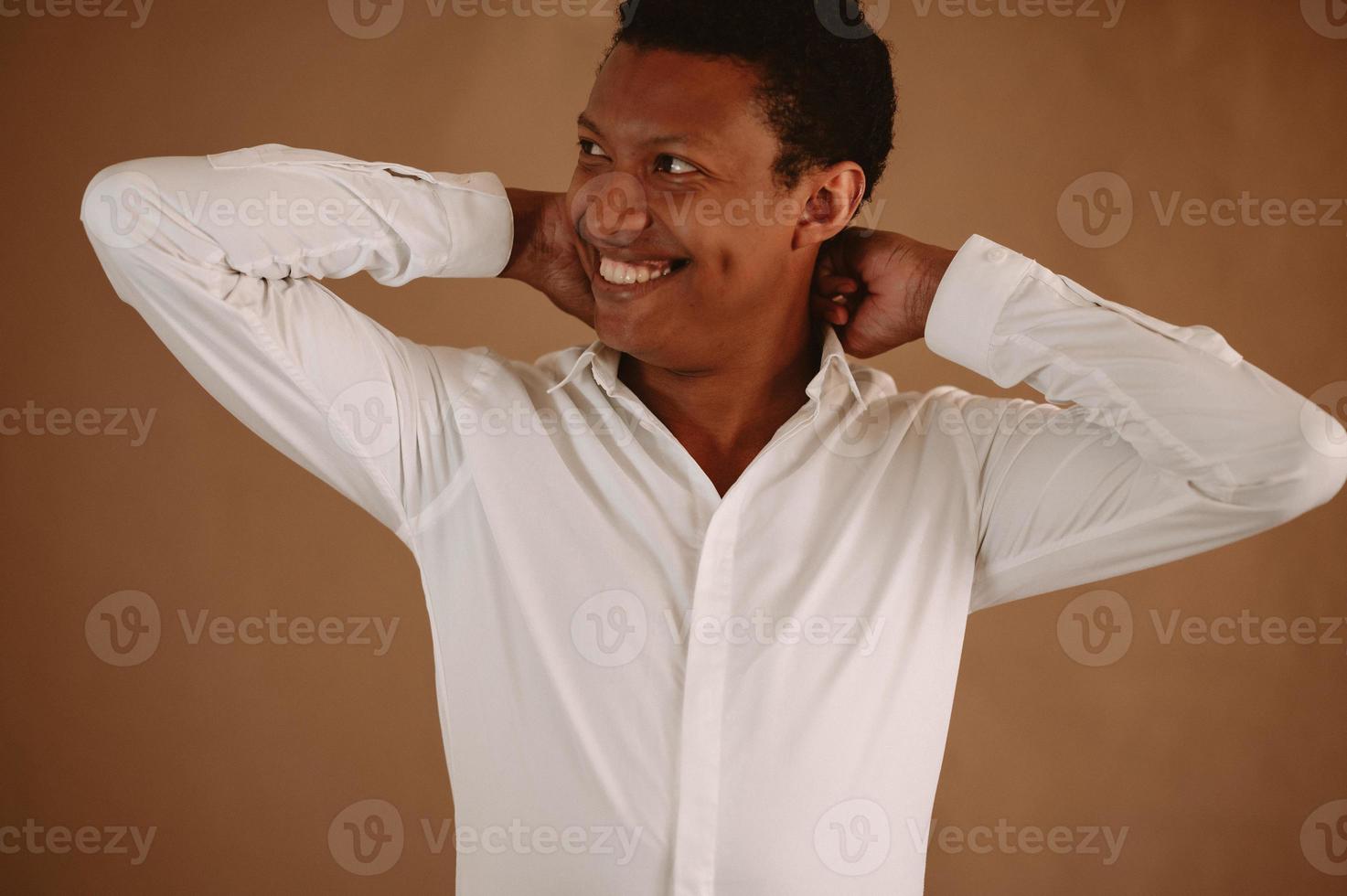 Young man in white shirt smiling photo