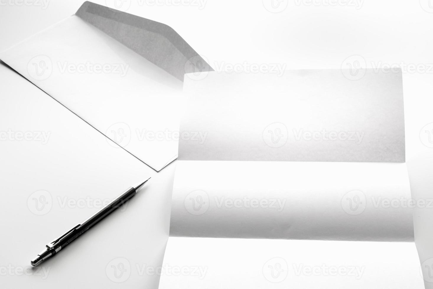 blank of letter paper and white envelope with pen photo