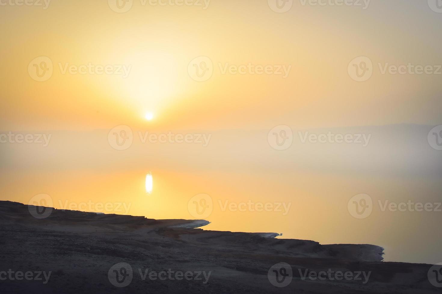 Dead Sea landscape, failures of the soil, illustrating an environmental catastrophe of Dead Sea. Salt crystals at sunset. Texture of Dead sea. Salty sea shore photo