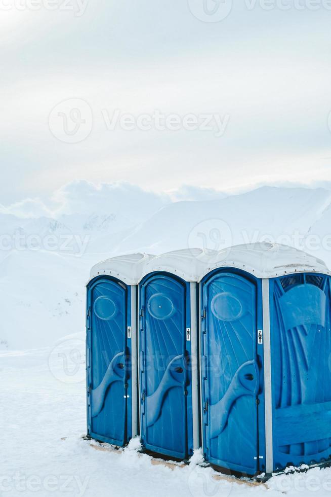 Portable blue toilets for skiers ski resort clients on top of mountain in Gudauri winter ski resort photo