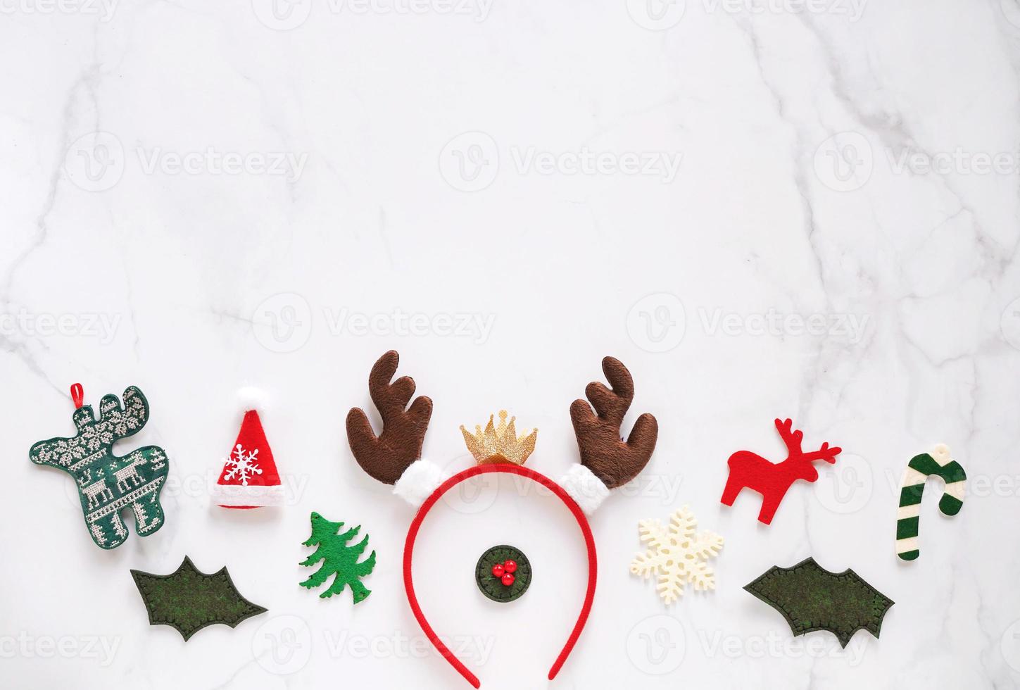 Fancy headband with reindeer antler and decorative christmas for party and celebration on white marble background, top view with copy space, holiday concept photo