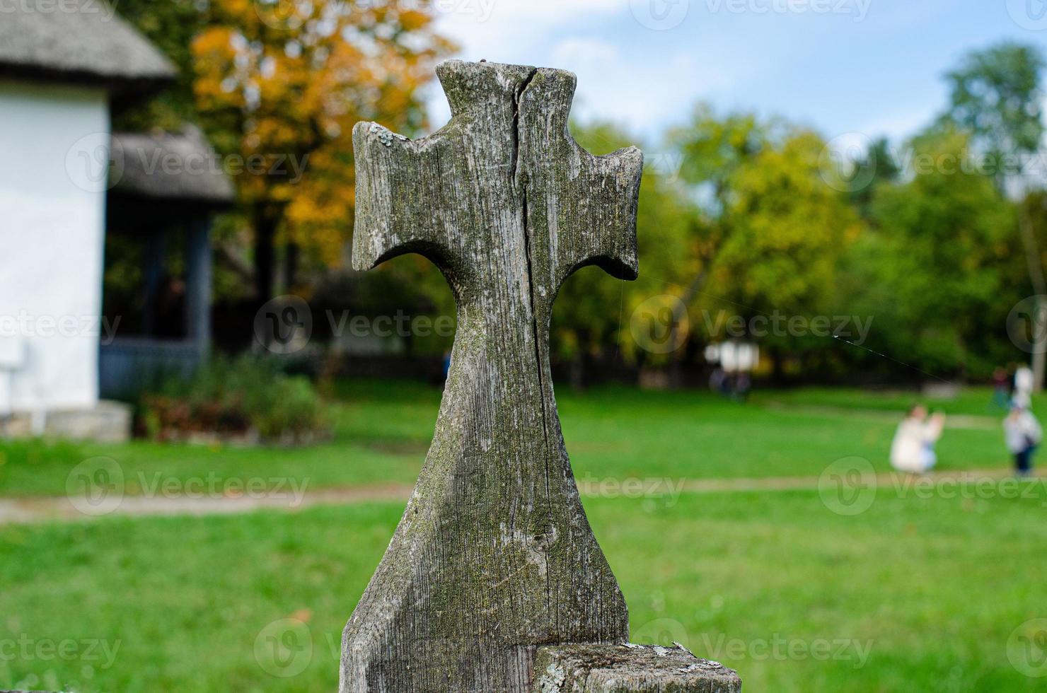 Ancient wooden Cross  on fence photo