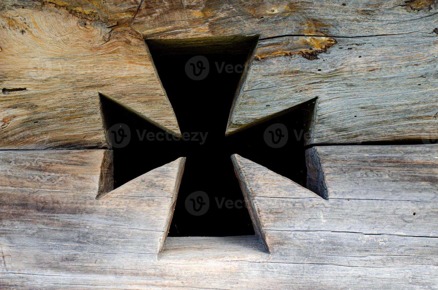 Ancient wooden cross  in wall photo