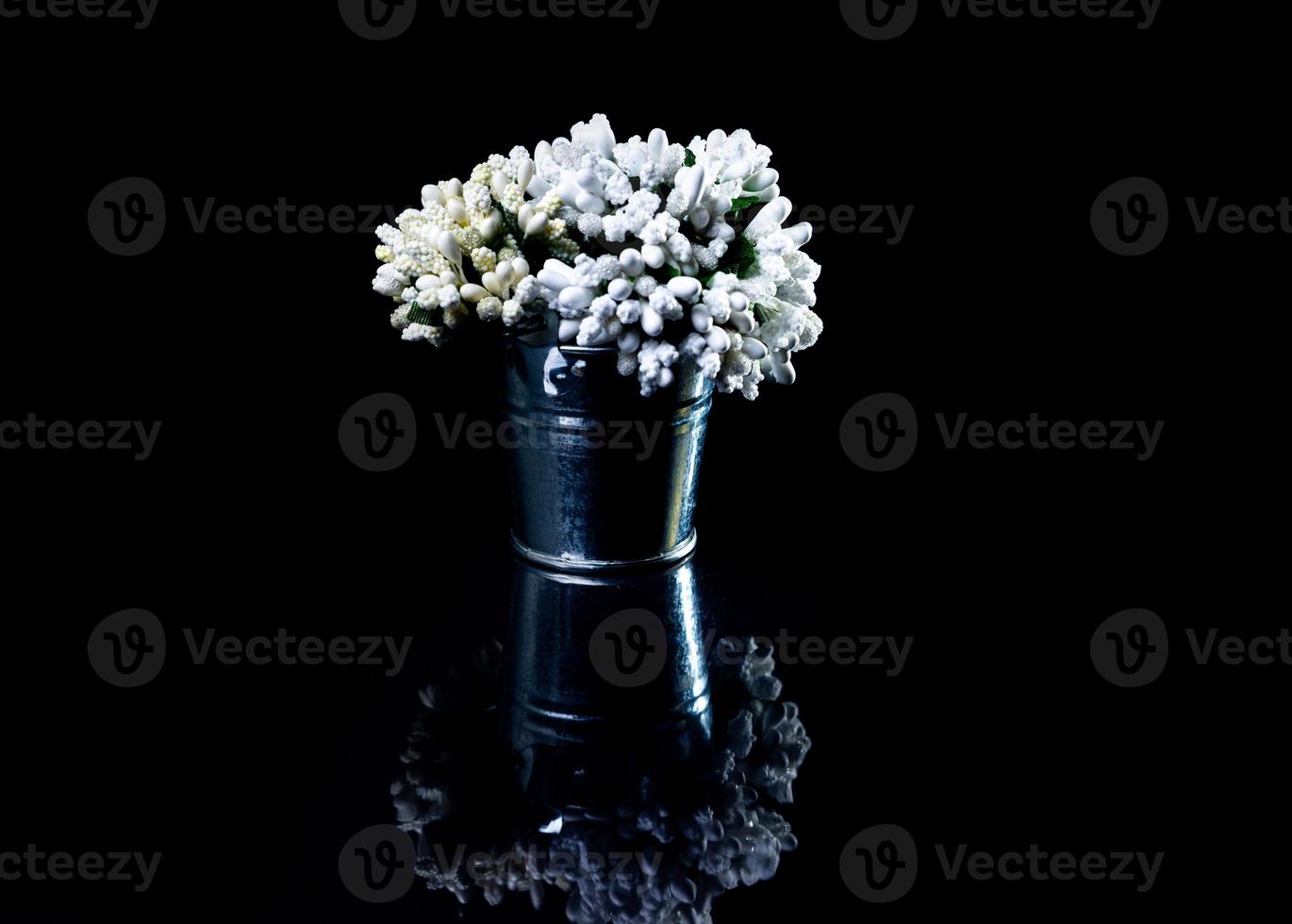aluminum ice bucket laid in wait for use. stainless multi-colored bucket with green blue flowers photo