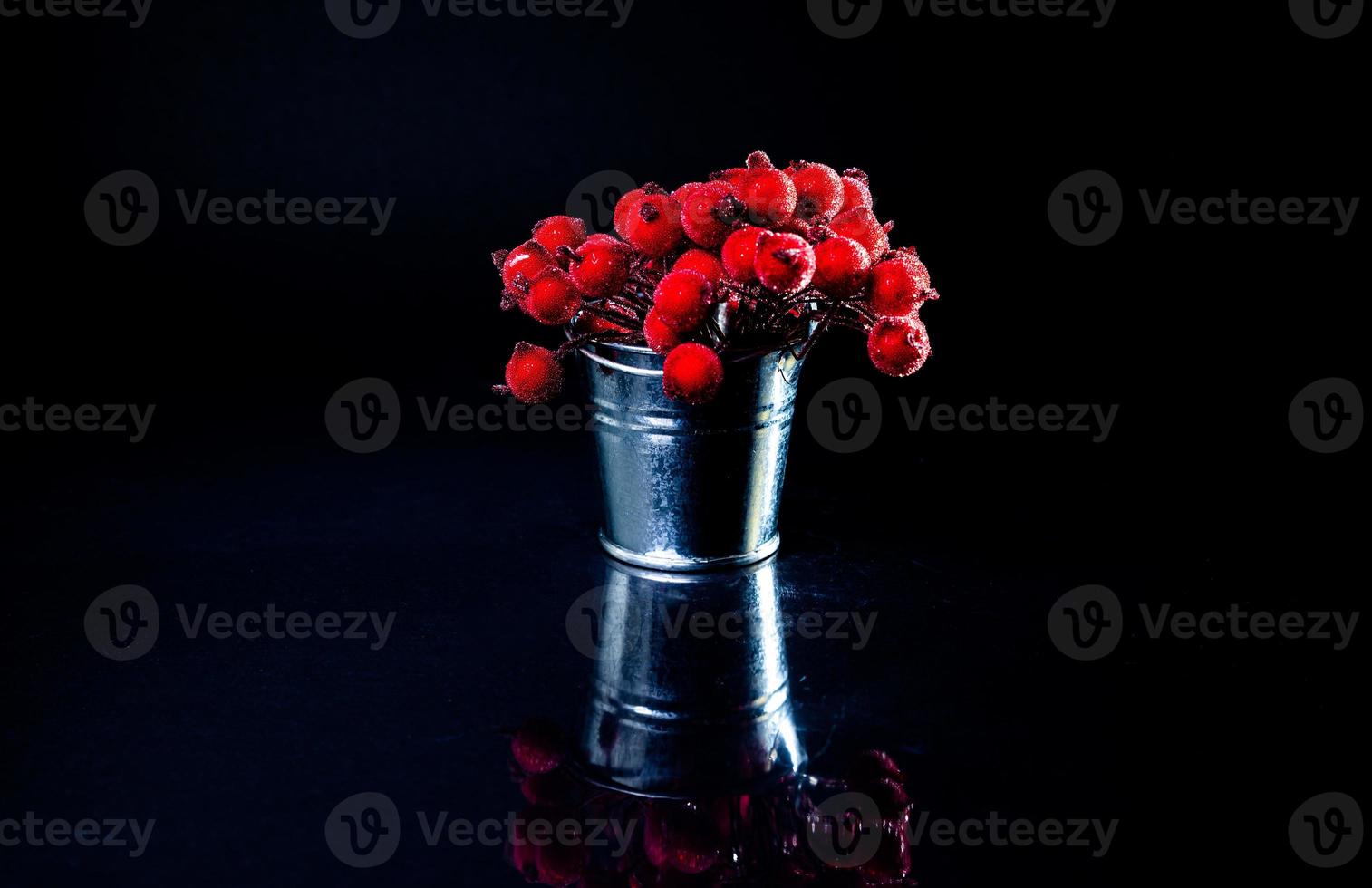 aluminum ice bucket laid in wait for use. stainless multi-colored bucket with red berries in ice photo