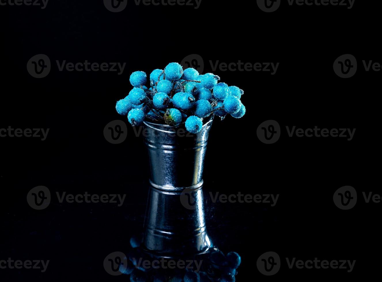 aluminum ice bucket laid in wait for use. stainless multi-colored bucket with green blue berries in ice photo