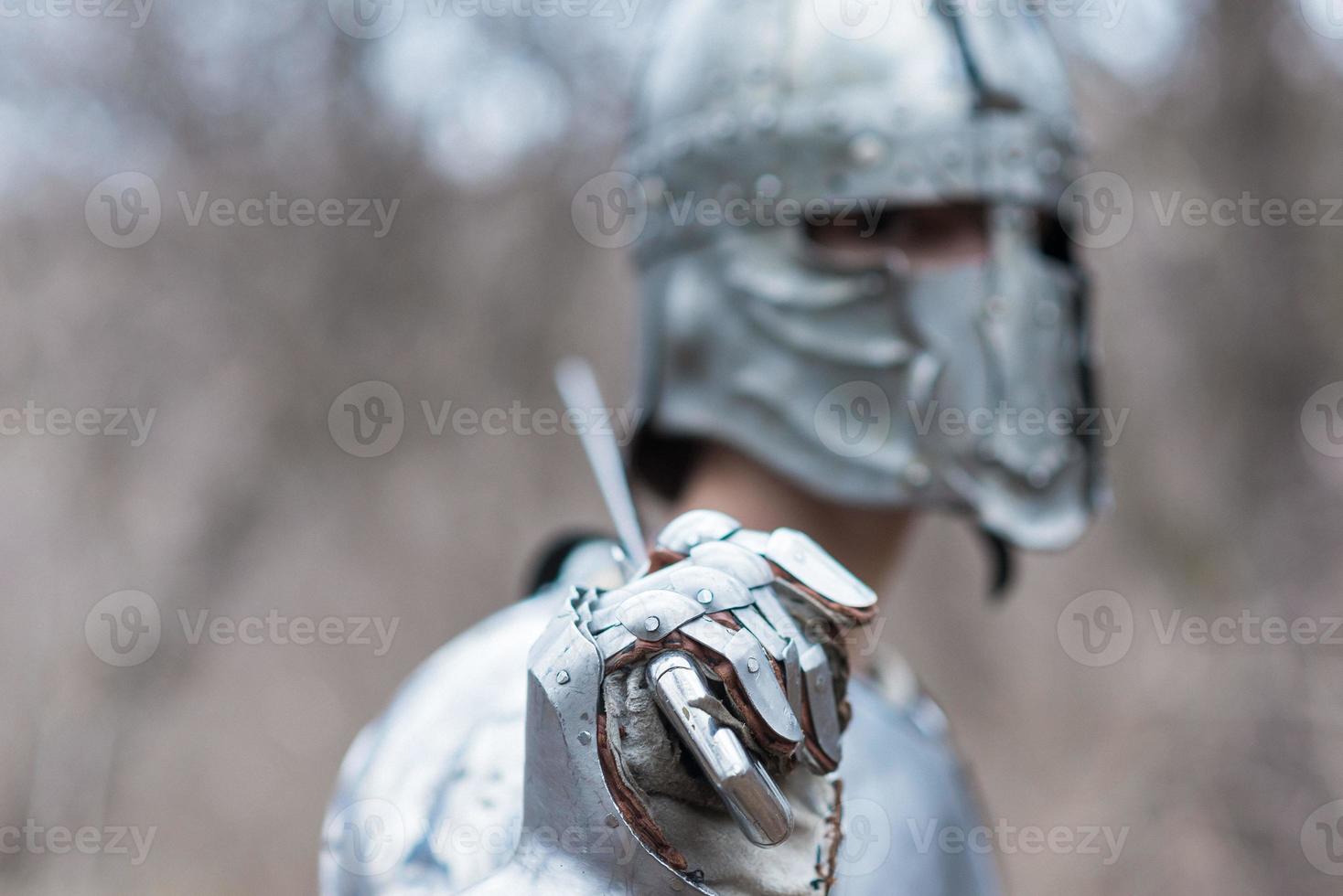 Noble warrior. Portrait of one medeival warrior or knight in armor and helmet with shield and sword posing photo