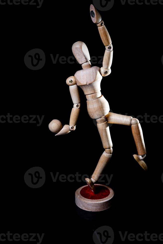 Image of wooden manikin on black background poses different posing photo