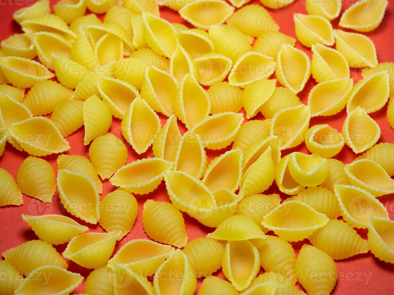 Shell-shaped pasta on the table.  Italian food.  durum wheat photo