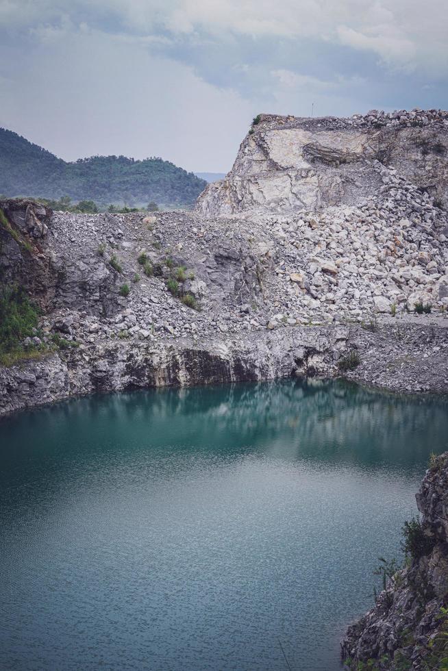 The limestone mountains after the concession explosion during the rainy season form a large and beautiful pond. photo